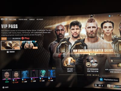 The image displays a screenshot of a video game menu, likely a fighting game like EA Sports UFC, as indicated by "UFC POINTS" and fighter imagery. The primary focus is a "VIP PASS" offering exclusive content such as fighter skins, vanity items, and boosts. The menu shows various UI elements including navigation tabs like "FIGHT STORE," "FIGHTER SKINS," "BUNDLES," and "UFC POINTS." Promotional graphics feature several fighters, some with championship belts. Below the main offer, there's a "FEATURED" section showcasing items for purchase with in-game currency. The bottom of the screen displays controller input prompts and PlayStation branding. There is no discernible information about the city of Kingston, Canada, in the image.