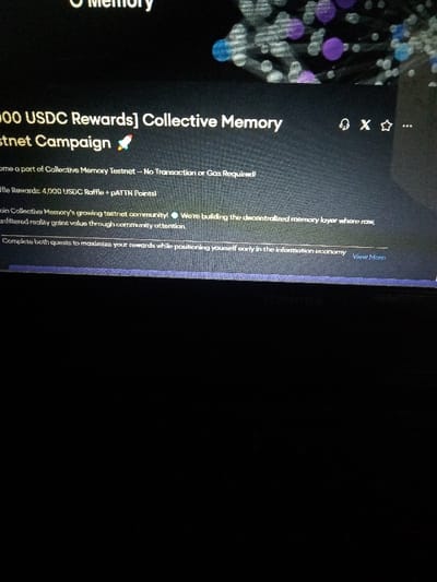 The image shows a computer screen displaying a website. The website features a headline that reads “4,000 USDC Rewards] Collective Memory Testnet Campaign.” There is a rocket emoji next to the text.  The text is in a white font against a dark blue background.  Below this headline, there is a description that reads “Become a part of Collective Memory Testnet - No Transaction or Gas Required!” The text is in a white font against a black background.  The next line reads “The Rewards: 4,000 USDC Raffle + pATTN Points!” The text is in a white font against a black background. Below this line is a section of text that reads “Join Collective Memory’s growing testnet community! We’re building the decentralized memory layer where raw, unfiltered reality gains value through community attention.” The text is in a white font against a black background. The final line of text reads “Complete both quests to maximize your rewards while positioning yourself early in the information economy.” The text is in a white font against a black background. There is a “View More” button at the end of the final line of text.  The image is of a screen displaying a website from an unidentified user at an unknown location. The coordinates provided are for Akoda, Nigeria, but this is not related to the image.