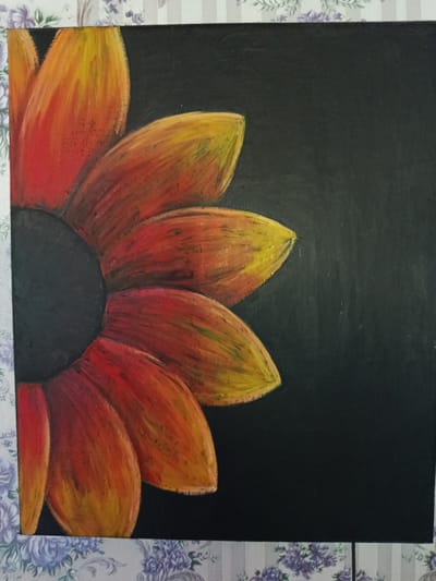 The image is a close-up, low-angle shot of a painting of a sunflower, rendered in warm tones of red, orange, and yellow, set against a stark black background. The sunflower petals are thick and textured, with visible brushstrokes that give them a vibrant, almost fiery appearance. The dark center of the sunflower is a deep, solid black, contrasting sharply with the colorful petals. The painting is framed by a decorative border featuring a floral pattern in shades of purple and gray. The image does not provide any information about the location of Chetroșica Veche, Moldova.