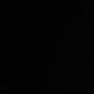 The image is entirely black, devoid of any discernible shapes, textures, or objects. It represents pure darkness, with no tonal variations or highlights. The absence of light and detail creates a void, suggesting an environment or space that is utterly empty. The overall impression is one of complete obscurity.