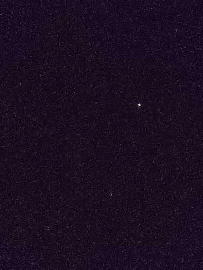 The image is a dark, blurry, grainy, black and purple picture of a seemingly empty sky with a single, tiny, white object located in the center. The coordinates correspond to a location in the Gulf of Paria, near the southwest coast of Trinidad, not the city of Mayo. It is impossible to determine what the tiny white object is.