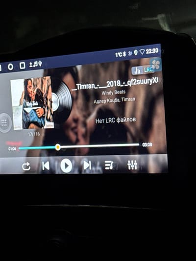 The image shows a car audio screen playing a song titled "_Timran_-_2018_-_qf2suuryXi" by Windy Beats and Adler Kotzba, Timran. It's 1:06 into the song, which is 3:08 long, and the current song is 17 out of 116 total. The display indicates that no LRC files are available. The screen also shows temperature of 1°C and the time 22:30, along with connection and status indicators.