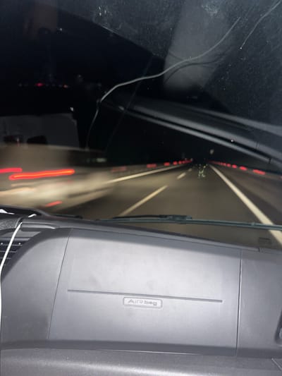 The image shows the interior of a car, specifically the dashboard and windshield, while driving through a tunnel. The "Airbag" label is visible on the dashboard. The view through the windshield shows the tunnel walls with lights, suggesting the car is in motion. The tunnel's location is purportedly in Malko Tranovo, Bulgaria.