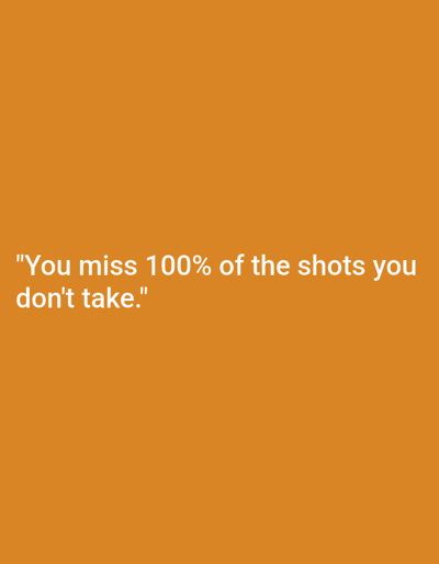 The image is a close-up, eye-level, indoor shot of a quote displayed on an orange background. The quote, in white, sans-serif text, reads: "You miss 100% of the shots you don't take." There are no people, subjects, or actions depicted. The environment is a plain, solid orange surface, suggesting a digital display or a simple wall. The location is not specified, and therefore cannot be identified as being in Worms, Germany.