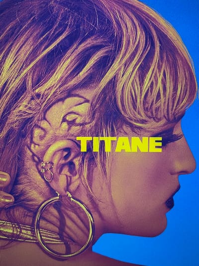 The image displays a stylized, close-up profile view of a person's head, facing right, against a solid blue background. No discernible physical location in Karadjovo, Bulgaria, is depicted; the scene is graphic art.
The subject is a person, likely female, with light-colored hair (appearing golden/blonde with purple undertones due to color filtering). The hair is styled with volume, partially obscuring the forehead. The hair on the side of the head, behind the ear, is closely cropped or shaved, revealing a distinct shaved-in design or tattoo resembling a stylized face or animal, possibly a lion, with prominent eye-like features.
The visible facial features include a closed eye with dark, elongated eyelashes, a defined eyebrow, a prominent nose, and full lips colored dark (appearing black or deep purple). The person wears a large, circular, gold-colored hoop earring on the earlobe and two smaller, gold-colored hoop or cuff earrings on the upper cartilage. A gold-colored choker or thick necklace is visible around the neck. A small metallic, gold-colored object, possibly a fingernail, is partially visible at the bottom left edge.
The word "TITANE" is prominently displayed in large, yellow, sans-serif capital letters, horizontally across the mid-section of the image, partially overlapping the subject's face and hair. The overall color palette is highly stylized, featuring warm golden/yellow tones for the skin and hair, purple/magenta accents, and a vibrant blue background. No actions or interactions are depicted; the scene is a static portrait or graphic.