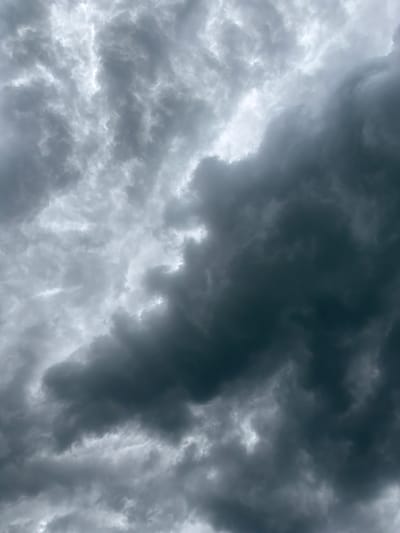 The image shows a sky filled with ominous, dark storm clouds. The clouds are a mix of gray and black, suggesting a heavy downpour or thunderstorm is imminent. The swirling patterns and textures of the clouds indicate turbulence and atmospheric instability. There are no people, subjects, objects, actions, or interactions visible. The environment is limited to the sky itself. There is no indication of the location being in Chkalov, Armenia or any city for that matter.