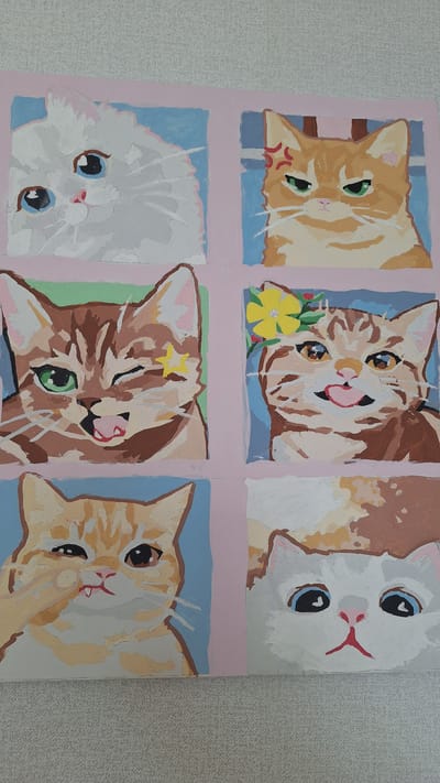 The image is a painting of six cats, each in a separate panel arranged in a two-by-three grid. The painting is on a textured surface, likely a wall. From top-left to bottom-right, the cats are: a fluffy white cat with blue eyes, an orange tabby with an angry expression, a brown tabby winking with a yellow star on its forehead, a brown tabby wearing a yellow flower and sticking its tongue out, an orange tabby with its paw near its mouth, and a white cat with large blue eyes. The painting style is illustrative and somewhat stylized, with bold colors and simplified forms. The background behind each cat is a pastel color, with pink borders separating the panels. There is no indication of the city of Nogliki, Russia, or any specific environmental details that would suggest a particular location.