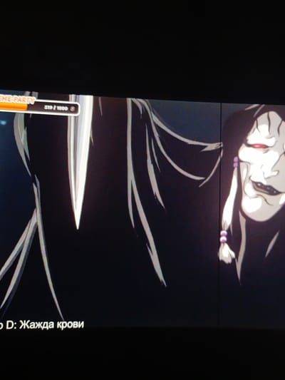 The image shows a screenshot from a video game. In the foreground, two stylized figures are depicted. The figure on the left is largely obscured by darkness, with only flowing white hair and a sliver of a sharp, pointed object visible. The figure on the right is more clearly rendered, appearing to be a person with white skin, red eyes, and a disturbing, wide smile. They have dark hair with a braid adorned with purple beads.
At the top of the image, a banner displays the text "SCENE PARTY" in orange letters. To the right of this, a progress bar shows "519 / 1000" with a circular icon.
At the bottom of the image, text in Cyrillic reads "o D: Жажда крови". This translates to "o D: Thirst for blood". The overall aesthetic suggests a dark fantasy or horror genre. The scene appears to be set in a fictional, possibly dangerous, environment. The emotions conveyed are sinister and menacing, primarily through the facial expression of the figure on the right. No specific time of day or weather is discernible, and the location is within the context of a video game interface.