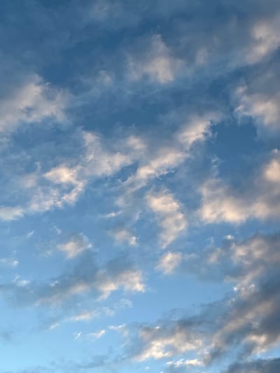 The image shows a sky with scattered clouds. The clouds vary in color from white to dark gray. Patches of blue sky are visible between the clouds. The image does not contain sufficient information to determine the location in El Bañado, Argentina, or any details about people, subjects, objects, actions, or interactions.