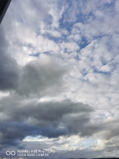 The image depicts a cloudy sky with a mix of dark and light clouds. In the lower portion of the image, a faint outline of land or trees can be seen against the horizon. There are no people or specific objects clearly visible in the sky or on the land. A watermark in the bottom left corner reads "HUAWEI P30 Pro LEICA QUAD CAMERA." There is no identifiable information within the image to pinpoint a specific location in Bad Oeynhausen, Germany.