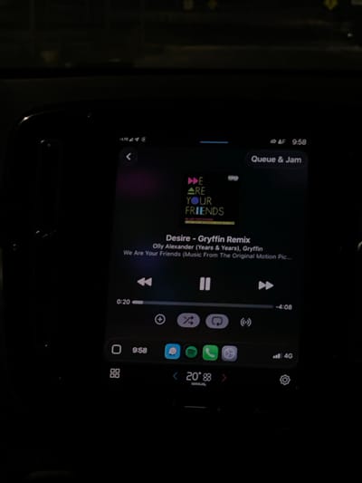 The image displays a dark, interior view of a vehicle at night, focusing on an illuminated digital infotainment screen. The screen is actively playing music, showing the album art for "We Are Your Friends" with the track "Desire - Gryffin Remix" by Olly Alexander (Years & Years) & Gryffin. The playback time indicates 0:20 elapsed and -4:08 remaining, with the song currently paused.
The interface includes system information such as "LTE" and "4G" network indicators, the current time "9:58," and a temperature reading of "20°." Below the music controls, a row of app icons is visible, including Discord, Spotify, and Phone. The dark surroundings suggest the image was captured within a car cabin, with faint, out-of-focus lights visible through the windshield in the upper background, indicating an external environment at night. No individuals are visible in the frame. The location is stated to be in the city of La Purísima, Mexico.