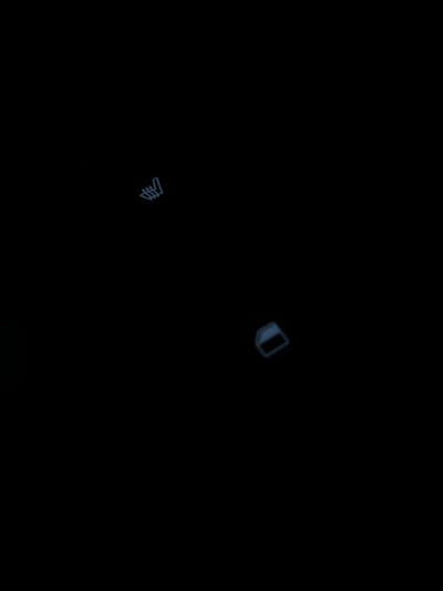 The image displays a dark, abstract scene with faint, glowing blue outlines of two geometric shapes. One shape, located in the upper left quadrant, resembles a stylized, multi-pronged fork or comb. The other shape, in the lower right quadrant, is a slightly distorted rectangle with rounded corners. The overall impression is one of minimalist digital art or a schematic representation. The image does not contain any discernible elements that would allow for its localization to Gorki-2, Russia, nor does it depict any people, actions, or interactions.
