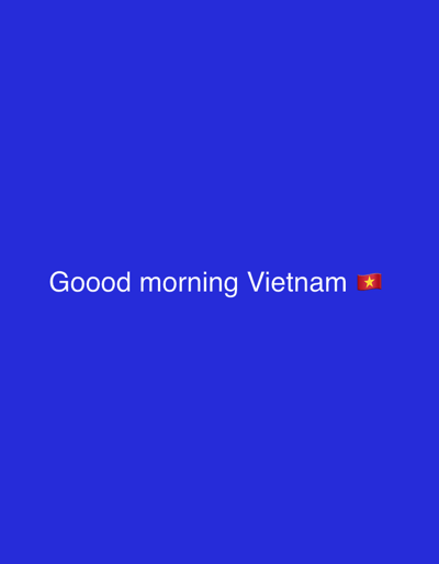 The media file is a solid blue background with white text that reads "Gooood morning Vietnam" followed by the Vietnamese flag emoji. There are no people, objects, or scenes visible, only text and an emoji on a plain background. The activity or event taking place is implied by the text, which is a greeting. No specific time of day, weather, or location cues are provided beyond the implied location in the text and the given context of Jihlava, Czechia, which is not depicted in the image. The emotion conveyed is a cheerful greeting.