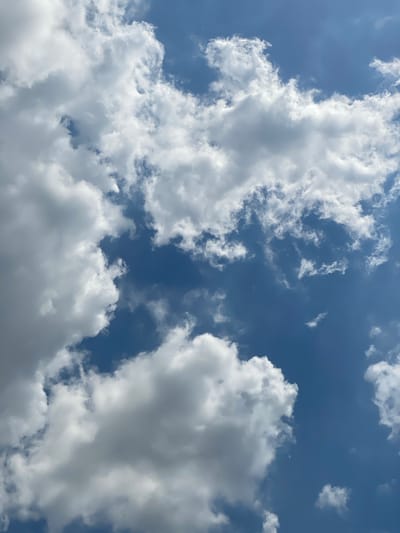 The image shows a cloudy blue sky with cumulus clouds. There is no indication of the city of Berangas Timur, Indonesia in the image. The scene is entirely natural and lacks any human elements or man-made objects.