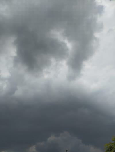 This is a photograph of a dramatic sky filled with dark, heavy clouds. The clouds are a mix of deep grays and lighter, overcast tones, suggesting a storm is either imminent or has recently passed. The texture of the clouds is varied, with some areas appearing smooth and diffused, while others have a more textured, turbulent look.

The scene is entirely dominated by the sky, with no discernible objects or people in the frame. The overall impression is one of a moody, overcast day. Given the location context of Romanivka, Ukraine, this image likely captures a weather event typical of the region. There is no visible text in the image. The lighting is diffused and atmospheric, consistent with a cloudy sky, and there are no strong shadows to indicate a specific time of day, though it appears to be daytime. The overall emotion evoked by the image is one of somberness or anticipation, due to the intensity of the storm clouds.