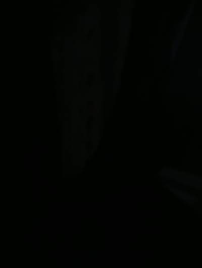 The media file is a close-up, low-light shot of a dark, possibly black, substance with a textured surface. It appears to be an abstract or detail shot, as there are no discernible people, objects, or a clear scene. The lighting is dim, creating a shadowy and somewhat mysterious atmosphere. The textured surface suggests a material that could be organic or manufactured, but its exact nature is unclear due to the darkness and lack of context. There are faint streaks of lighter color, possibly highlights or reflections, that add a subtle dynamism to the otherwise uniform dark mass. No text is visible in the image. The overall impression is one of depth and perhaps a tactile quality, but the lack of environmental cues makes it difficult to determine the specific setting or time of day.