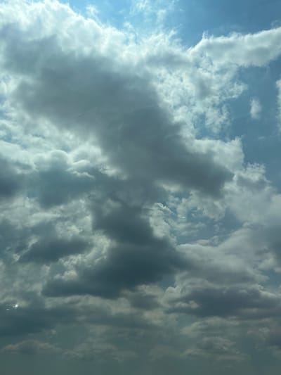 The image captures a cloudy sky above what appears to be Vratitsa, Bulgaria. The clouds are a mix of dark gray and white, with some patches of blue sky visible. The lighting suggests it may be daytime, possibly with the sun partially obscured by the clouds. No specific landmarks or discernible features of the city are visible, as the focus is solely on the sky. There are no people, subjects, objects, or actions depicted in the image.