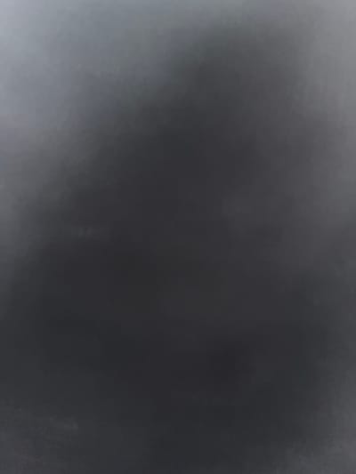 The image is a close-up shot of a dark, textured surface, possibly a wall or fabric. The lighting is dim, with a gradient of light and shadow across the frame. There are no people, objects, or discernable features within the image. The provided crops offer slight variations in brightness and texture, but do not reveal any additional details or context. There is no information available within the image to place it in the city of Rosenovo, Bulgaria.