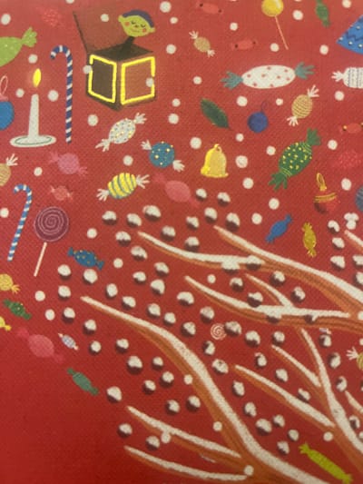 The image is a close-up of a red textured surface, likely fabric or paper, decorated with a festive, childlike illustration. The dominant theme is candy and holiday elements. Scattered across the red background are numerous white dots, resembling snow or confetti.
Key objects depicted include:
- A jack-in-the-box with a smiling green-faced character emerging from a dark box, outlined with bright yellow light.
- A white candle with a lit yellow flame.
- A blue and white striped candy cane.
- A purple lollipop on a stick.
- Various colorful candies in different shapes and patterns, including white with red dots, yellow and green striped, and blue with white dots.
- A yellow bell.
- Green leaves.
- Blue and red decorative ornaments.
- A blue Christmas tree-shaped object with a gold star at the top.
- A collection of brown and white circular shapes, some with dark centers, arranged in clusters.
- White and orange brushstrokes or painted elements that suggest branches or abstract shapes with a snowy texture.
The style is simplistic and cartoonish, indicative of a children's illustration or a festive decorative item. There are no people depicted other than the character in the jack-in-the-box. The image does not contain any elements that suggest a specific location in the city of Edem, Russia.