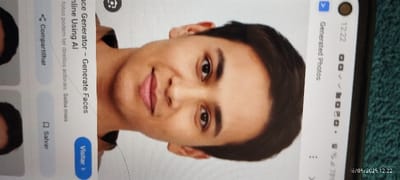 The image shows a close-up of a man's face. The image is from a phone screen, showing the results of a face generation tool. The phone is angled slightly to the left. The man has dark brown hair, brown eyes, and a light complexion. He is smiling slightly and looking directly at the camera. The background is a plain white surface. The image is cropped at the top and bottom of the frame. The coordinates provided are for the city of João Pessoa, Brazil. However, the image does not contain any contextual information about this location.  The image is being displayed on a phone screen, with the text "Face Generator - Generate Faces Online Using AI" visible at the top of the screen.  There are several small white squares and a button labeled "Visitar" in a blue background. The phone's date and time are visible at the bottom right corner of the image.