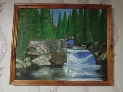 A framed oil painting depicts a serene natural scene, likely inspired by a location in Atbasar, Kazakhstan. The primary subject is a cascading waterfall surrounded by lush, green coniferous trees. The waterfall is depicted as a dynamic element, with white foam and blue water rushing down rocky formations into a calm pool below. The pool reflects the surrounding landscape, including the trees and the sky. The time of day appears to be daytime, with bright, clear lighting illuminating the scene. The weather seems pleasant and calm, contributing to the tranquil atmosphere of the painting.
The setting is a forest with dense trees, suggesting a wild and untouched natural environment. Large rocks and boulders are prominent features, framing the waterfall and the pool. The water itself is rendered with brushstrokes that convey movement and texture. The color palette is dominated by various shades of green for the foliage, blues and whites for the water, and grays and browns for the rocks. The overall mood of the painting is peaceful and evocative of the beauty of nature. There is no visible text in the image.