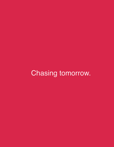 The image is a simple, minimalist graphic with a solid, vibrant pink background. Centered on the background in white, sans-serif text is the phrase "Chasing tomorrow." The text is the only discernible subject in the image. There are no people, objects, or environmental details visible. The graphic appears to be a digital image, possibly a title card or a motivational quote displayed online or on a screen. The lack of any other visual elements creates a stark and direct presentation of the text.