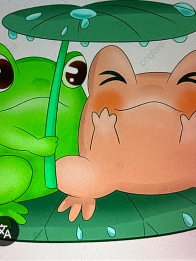 Two cartoon frogs are depicted under a large green leaf, serving as an umbrella during a rain shower. The frog on the left is green and is holding the stem of the leaf umbrella. The frog on the right is an orangey-brown color and appears to be smiling with its hands raised near its face. Water droplets are visible on the leaf, indicating it is raining. The scene is set on another large green leaf, which is tilted and has water droplets on it as well. The overall impression is one of cuteness and shelter from the rain. There is no recognizable connection to the city of Babahjurong, Indonesia, as the image depicts a fictional, stylized scene.