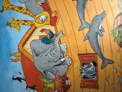 This image is an illustration from a children's book depicting Noah's Ark. The scene is set on a wooden boat, likely the Ark, with a blue background suggesting water or sky. A portion of Noah's Ark is visible, characterized by its wooden planks and an open window-like structure.
The main subjects are various animals and a human figure, presumably Noah. Two giraffes are prominently featured, with their heads and necks extending into the frame. An elephant is depicted in a large, grey form, with its trunk and legs visible. Other animals include a rooster perched on a wooden beam, several penguins at the lower left of the frame, and a zebra peeking out of the window. Dolphins are shown in the water, one with its head and tail fin clearly visible. A frog is also present near the dolphins. The human figure, believed to be Noah, is shown in a red robe with a yellow head covering, with his hands clasped.
The activity appears to be the gathering of animals onto Noah's Ark, as suggested by the narrative context of the scene. The overall tone is whimsical and child-friendly, with vibrant colors and stylized depictions of the animals. There are no explicit indications of time of day or weather, other than the blue background suggesting an outdoor setting. No text is visible in the image.