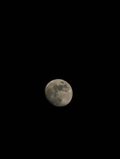 The image shows a full moon against a completely black sky. There are no other visible objects or details in the scene. There is no indication of the location, Trachoni, Cyprus, or any other city, people, subjects, objects, actions, interactions, or any other environmental details.
