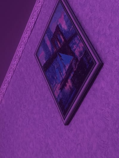 The image shows a painting hanging on a textured wall. The painting is framed and appears to be an abstract or modern art piece with shades of blue, pink, and black. The wall has a textured finish, and to the left of the painting, there is a decorative border or trim. The overall lighting of the scene is tinted purple, suggesting it may be a nighttime photo or a deliberate lighting effect. There are no people visible in the image, and no specific details about the location in Khrenovoye, Russia are apparent from the visual information provided.