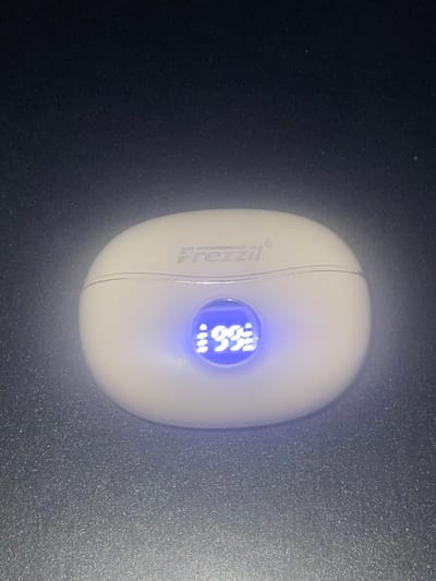 A white, oval-shaped device with the brand name "Frezzzil" on its left side sits on a dark, matte surface. The device has a circular blue-lit display showing "96.6". It's unclear if this is indoors or outdoors but it is impossible to determine if it is located in the city of Abraka, Nigeria, due to the lack of landmarks or other contextual clues.