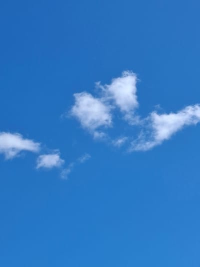 The image displays a clear blue sky with scattered white clouds. There are no people, subjects, or objects visible in the scene besides the clouds and the sky. The environment is that of an outdoor sky. The location in Mänttä-Vilppula, Finland is not determinable from the visual information present in the image.