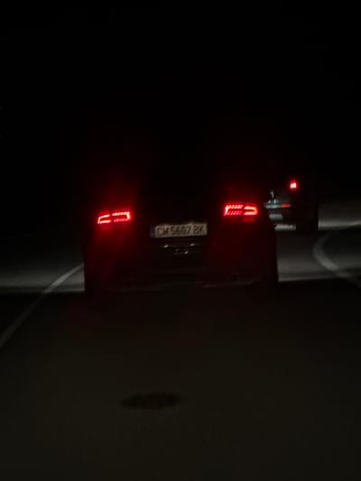 A dark image of the rear of a vehicle. The license plate reads "CA 5697 BK." The location appears to be in Narechenski bani, Bulgaria, based on the license plate format. The scene includes the vehicle, its taillights, and the surrounding road or pavement. There are no people visible. The environment is dark, possibly at night.