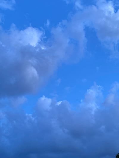 The image shows a cloudy sky with a dominant blue hue. The clouds are varied in texture and density, with some appearing wispy and light, while others are darker and more substantial. There is no discernible city, human presence, or activity visible. The scene is entirely composed of the sky and clouds, suggesting an outdoor environment, but no specific geographical markers place it in Rinteln, Germany or any other location.