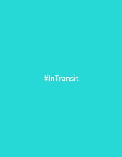 The image is a solid, bright teal background. Centered on the background is the hashtag "#InTransit" in white, sans-serif text. The image contains no other discernible objects or subjects. The location of Roghun, Tajikistan, is not depicted or referenced in the image.