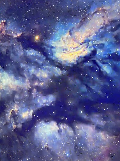 The image displays a close-up view of a nebula, a celestial cloud of dust and gas in outer space, illuminated by stars. The nebula is characterized by swirling patterns of deep blues and purples, interspersed with bright, wispy streaks of yellow and white light. Numerous small, white dots scattered throughout the image represent distant stars. One larger, bright star with a golden hue is visible in the lower left quadrant. The overall impression is one of cosmic grandeur and vastness, with no discernible human presence or earthly features. The scene is entirely abstract and astronomical, lacking any indicators of time of day, weather, or specific location beyond the general context of space. There is no visible text in the image.