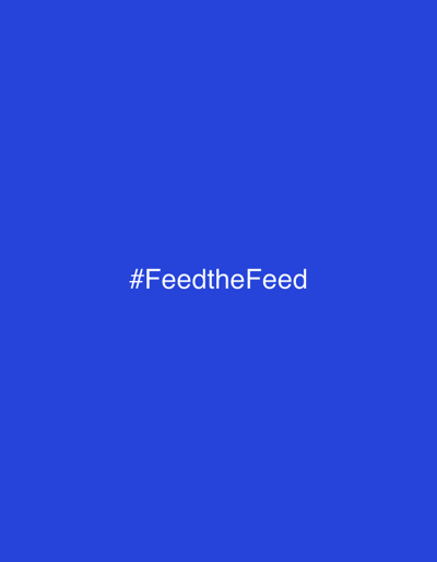The image displays a minimalist composition with a solid, deep blue background. Centered on the background is white text that reads "#FeedtheFeed". The text is presented in a simple, sans-serif font. There are no other objects, people, or discernible elements in the image. The lighting is even, with no shadows or highlights, suggesting a studio or digitally generated environment. The overall impression is clean and graphic, with the text being the sole focus. The provided location context of "Marina di Ravenna, Italy" does not offer any visual cues within the image itself, as the image is entirely abstract. There are no indications of time of day, weather, or emotions.