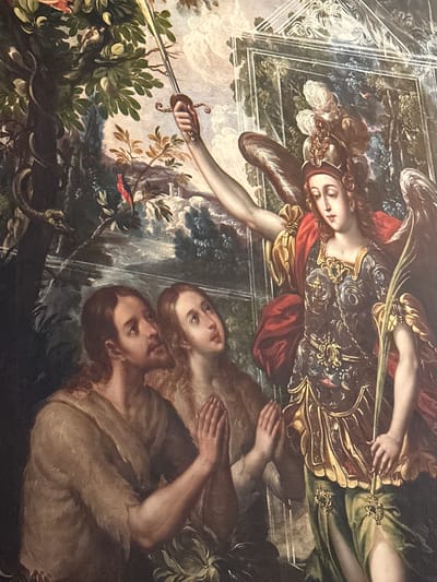This painting depicts the biblical scene of the Expulsion from the Garden of Eden. On the left, a majestic angel, likely Archangel Michael, is shown in flight or descending. The angel wears ornate golden armor over a red tunic and green drapery, with large, feathery wings extending behind. A sword with a decorative hilt is held in the angel's right hand, pointed downwards towards the figures below, indicating their expulsion. The angel's face shows a solemn, determined, yet possibly sorrowful expression.
To the right, huddling together in distress, are two nude figures, a man and a woman, representing Adam and Eve. They embrace tightly, with the man's arm around the woman and his hand covering her breast, conveying shame and sorrow. Both look upwards at the angel with expressions of fear and despair. The man has a beard and long dark hair, while the woman also has long, flowing hair.
The setting is a dense, lush garden filled with rich green foliage, trees, and scattered colorful birds. In the lower right, coiled on the ground near Adam and Eve, is a dark snake with its mouth slightly ajar, symbolizing its role in the temptation. The background includes glimpses of a brighter, cloud-filled sky and distant natural elements. The painting features a dramatic, detailed style, characteristic of Baroque artistry. There is no visible text in the image. This artwork is located in Tepotzotlán, Mexico.