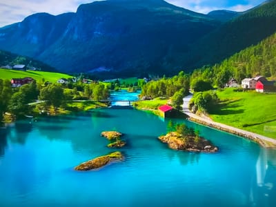 The image displays a scenic landscape featuring a vibrant turquoise lake with several small, rocky islands. Lush green meadows and forests flank the water, contrasting with the dark blue, mountainous backdrop. A few houses with red roofs dot the landscape. A bridge spans a narrow part of the lake, and a road runs alongside the water's edge.
This scene does NOT appear to be located in Basingstoke and Deane, United Kingdom. The landscape is consistent with the fjords found in Norway.