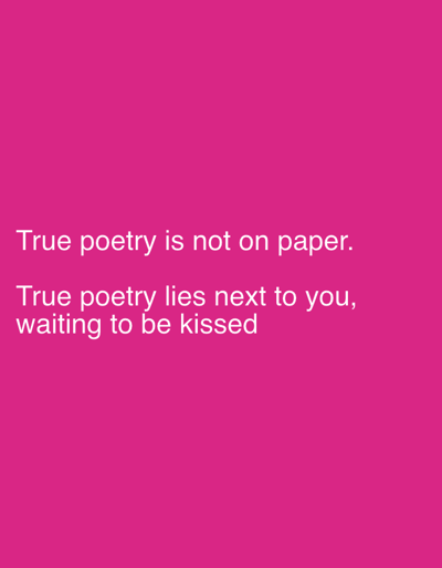 The image, located in the city of Stornara, Italy, features a solid magenta background. White sans-serif text is displayed on the background, stating: "True poetry is not on paper. True poetry lies next to you, waiting to be kissed." No individuals, specific objects, actions, interactions, or discernible environments beyond the color field are present.