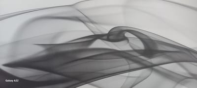 The image is a close-up, abstract depiction of flowing, semi-transparent gray fabric or smoke against a white background. The fabric creates undulating curves and overlapping layers, suggesting movement and depth. The lighting is soft, creating subtle shadows and highlights that emphasize the translucent quality of the material. The bottom left corner of the image contains the text "Galaxy A22". There is no information in the image that allows for identification of a specific location in the city of Oral, Kazakhstan.