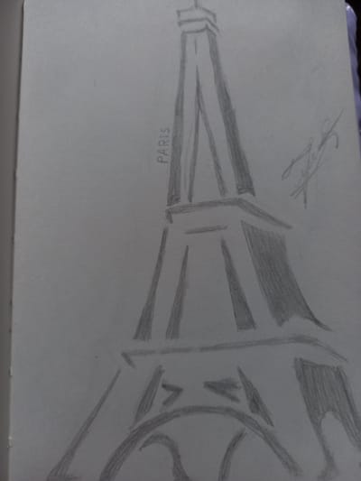 The image is a pencil sketch of the Eiffel Tower. The drawing is done on a white piece of paper, and the perspective is from a low angle looking up at the tower. The Eiffel Tower is depicted with its characteristic lattice structure, with bold lines and shading used to create depth and form. The base of the tower is visible, and it appears to be in the process of being drawn. The word "PARIS" is written horizontally along the bottom left of the tower in capital letters. In the upper left corner of the drawing, there is a faint signature. The drawing suggests a representation of a famous landmark without any specific environmental details, nor are there any indications of time of day, weather, or emotion. The provided location context of Keles, Uzbekistan, does not appear to be represented in the image itself.