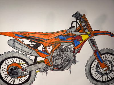 The image is a colored pencil drawing of a dirt bike, likely a KTM given the logo visible on the fuel tank. The bike is depicted in profile, facing left. It features an orange and blue color scheme with accents of yellow and red, including the iconic Red Bull logo. The engine and suspension components are rendered in gray and black. The wheels are large with knobby tires, characteristic of off-road motorcycles. The drawing is set against a plain white background, giving no indication of its location. There are no people or actions depicted in the image. The drawing appears to be an artist's rendering and not a photograph of a real-world scene.