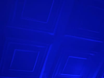 The image shows a blue ceiling with recessed square panels. There is no indication of the location in the city of Rumuigbo, Nigeria. No people, subjects, objects, actions, or interactions are visible.