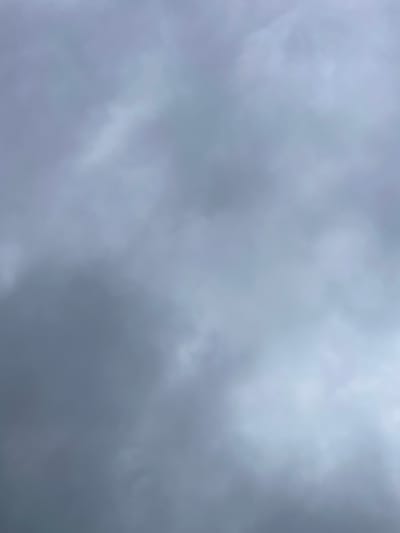 The image shows a sky filled with dark, overcast clouds, suggesting a gloomy or stormy atmosphere. There are no people, subjects, or objects visible, and no discernible environmental features such as buildings or landscapes. The image is entirely composed of abstract cloud formations. The image does not contain any information that would allow for its location to be determined within Protasy, Russia.
