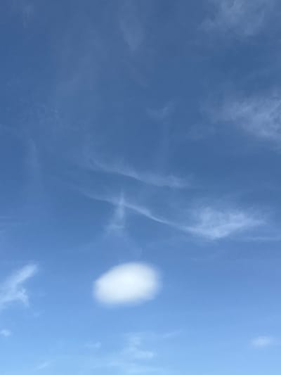 The image shows a blue sky with wispy clouds. A distinct, round, bright white cloud is visible on the right side of the frame. Based on the provided information, the location is Severnyi, Russia, though no specific details relating to that location are discernible in the image itself.