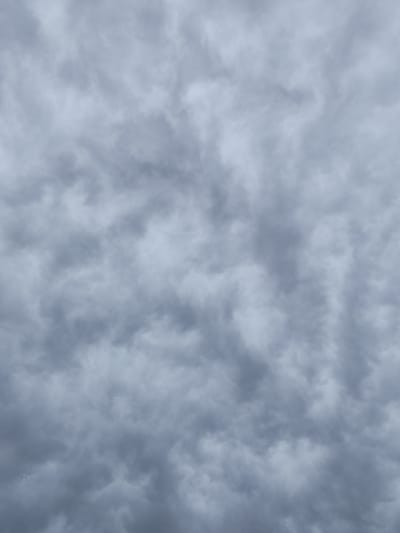 This media file shows a sky filled with dark, ominous clouds. The clouds are heavy and textured, suggesting an impending storm or overcast weather. There are no visible objects, people, or specific location cues within the frame, other than the general context of Dolan, Kazakhstan. The lighting is dim, indicating it could be late afternoon or an overcast day. The overall mood conveyed by the image is one of gloom and foreboding due to the heavy cloud cover. There is no visible text in the image. The scene is a natural one, focusing solely on the atmospheric conditions.