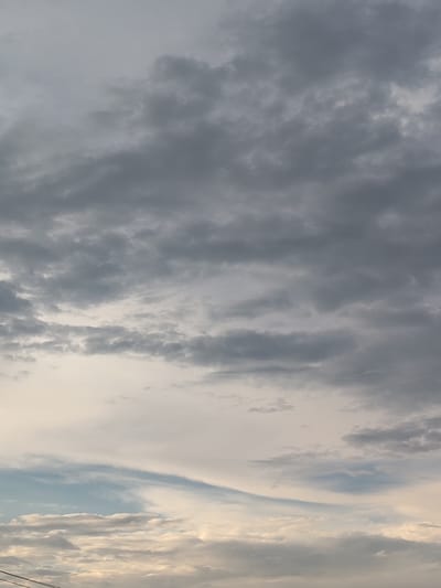 The image shows a cloudy sky. The clouds are various shades of gray, with some lighter areas suggesting breaks in the cloud cover. There are no visible buildings, people, or objects in the image, just the expanse of the sky. The location in Skurygino, Russia is not discernible from the image itself.
