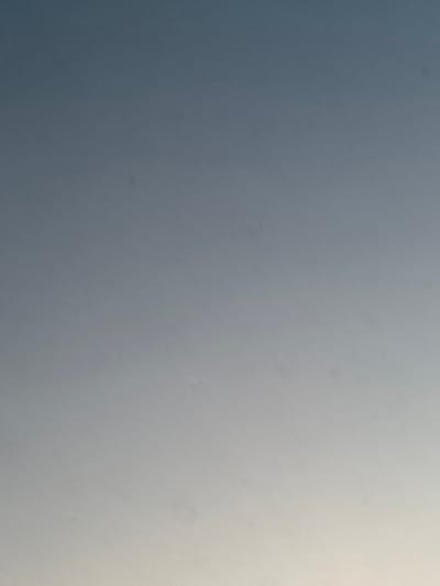 This is a still image with no discernible subjects, objects, scene, or activity. It is an abstract composition of varying shades of gray, transitioning from a darker gray on the left to a lighter, almost white gray on the right. The texture of the image is grainy, suggesting it may be a photograph or a digital rendering with a textured effect. There are no visible details such as time of day, weather, location cues, emotions, or text. The provided location context of Bol'shoe Sareevo, Russia, does not offer any clues to interpret the abstract visual content.