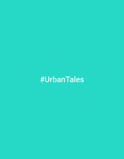 The image displays a minimalist graphic featuring a solid, vibrant teal background. Centered on this uniform backdrop is white, sans-serif text. The text clearly reads "#UrbanTales", presented as a hashtag. There are no people, objects, or any discernible scene elements beyond the colored background and the text. No activity or event is depicted. The image is a simple design, focusing solely on the brand or concept suggested by the hashtag. No specific time of day, weather conditions, or geographical location can be inferred from the visual information provided.